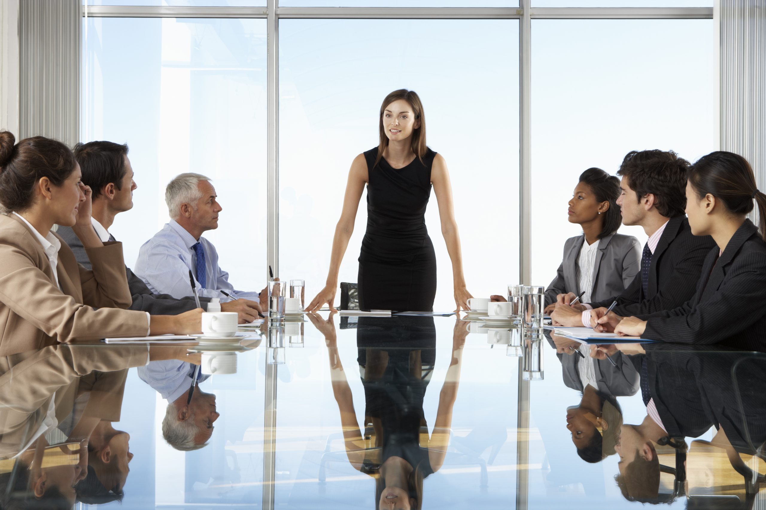 Group Of Business People Having Board Meeting Around Glass Table Group Of Business People Having Board Meeting Around Glass Table