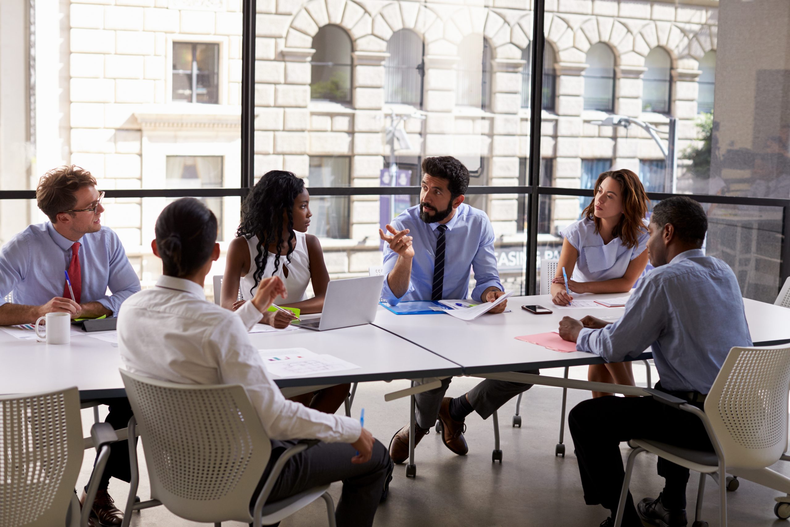 Accountants sitting at table - Sheer Velocity accounting recruiters