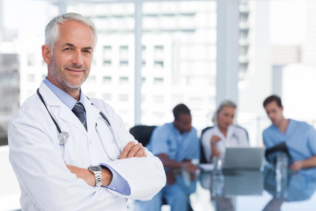 Smiling doctor with folded arms in healthcare setting